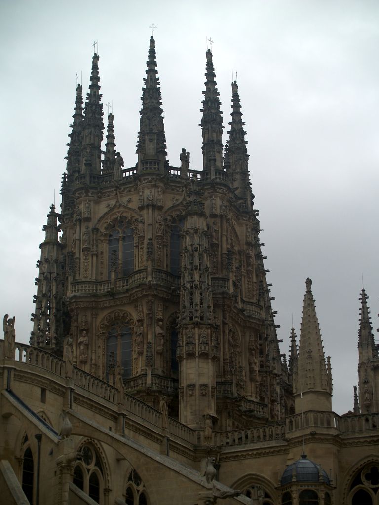 An ornate stone lantern tower with tall windows, sculpture and pinnacles rises above surrounding cathedral roofs.