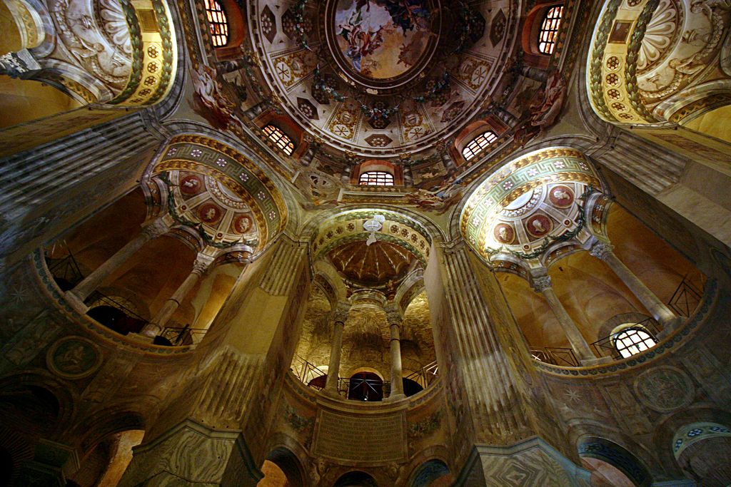 Curved arcades, slender columns and richly painted vaults rise toward a dome in the central interior of San Vitale.