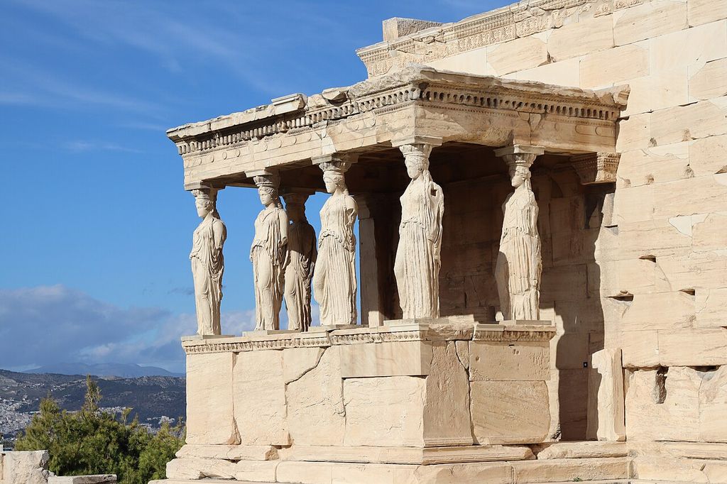 Female-form copies stand on a raised porch, their heads beneath a horizontal entablature.