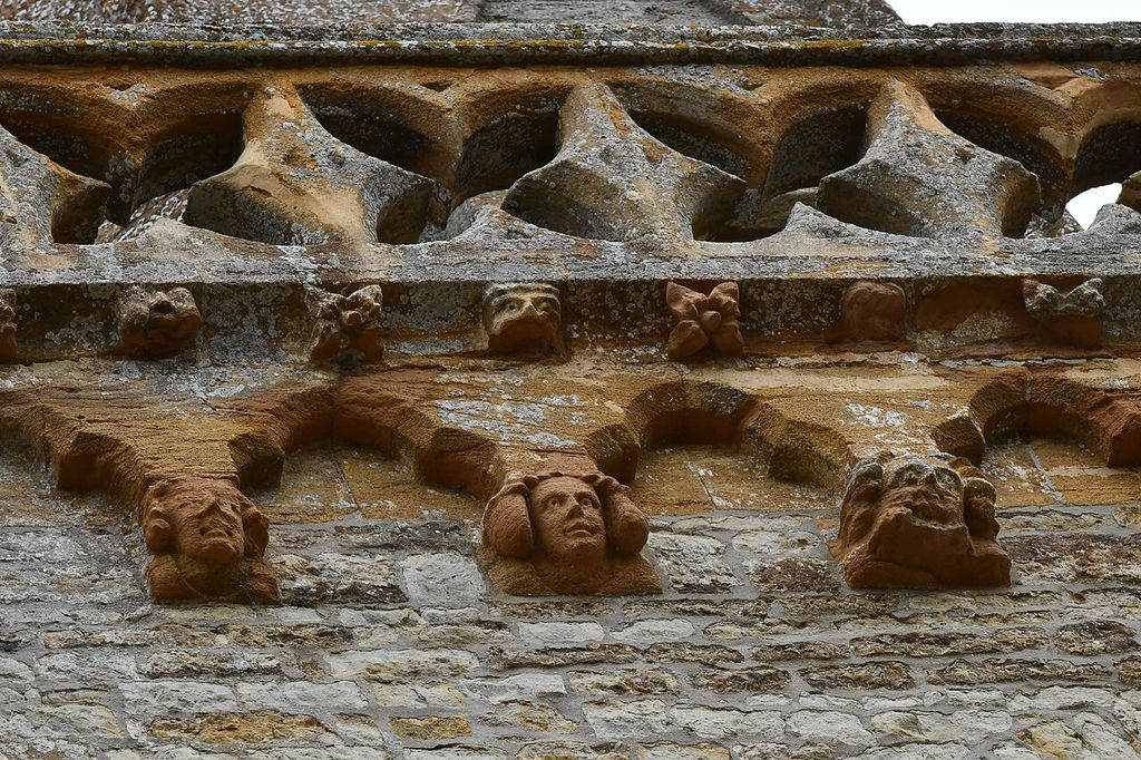 Trent, St. Andrew's Church, Tower parapet of pierced quatrefoils above head corbels - geograph.org.uk - 8136613, an architectural view.