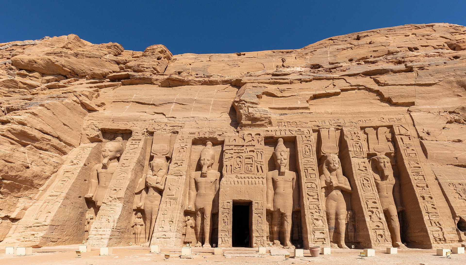 Full Small Temple sandstone façade with six standing royal colossi around its doorway, two representing Nefertari and four Ramesses II.
