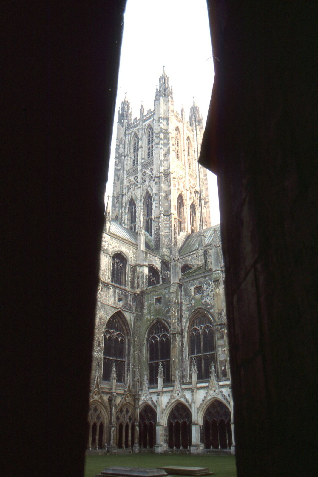 Canterbury Cathedral's octagonal Bell Harry tower rises above the stone-vaulted cloister walk and its traceried openings.