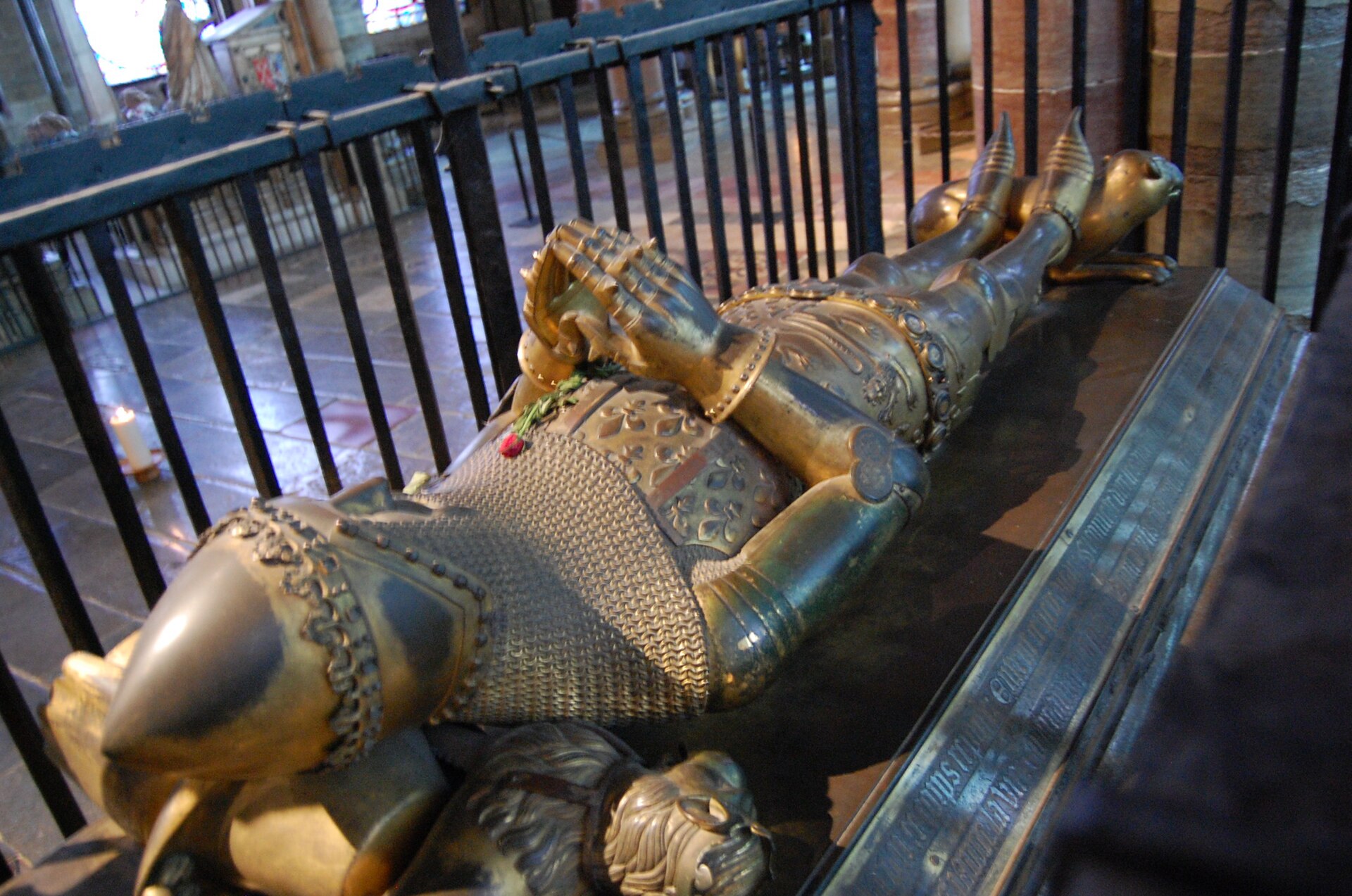 The tomb of Edward the Black Prince in Trinity Chapel, with a gilded recumbent effigy on a Purbeck marble chest beneath a timber tester.