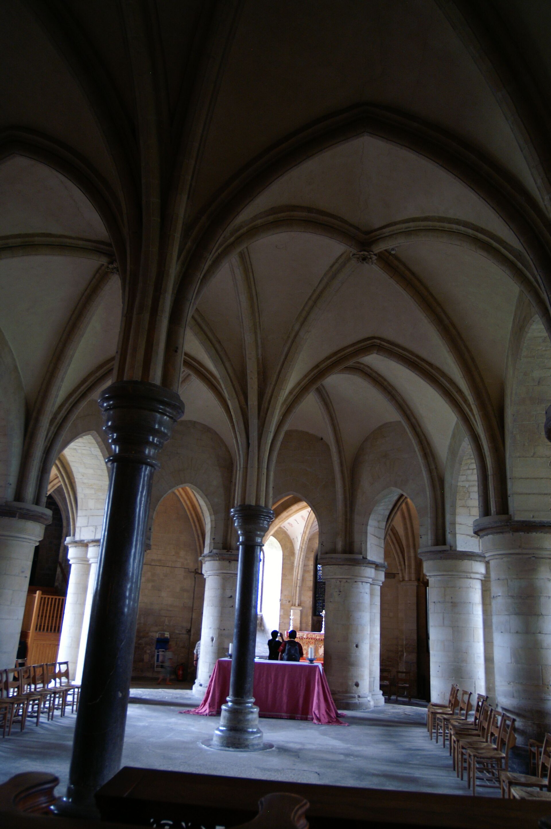 The eastern crypt beneath Trinity Chapel, with short columns, carved capitals and low ribbed vaults carrying the raised pilgrimage space above.