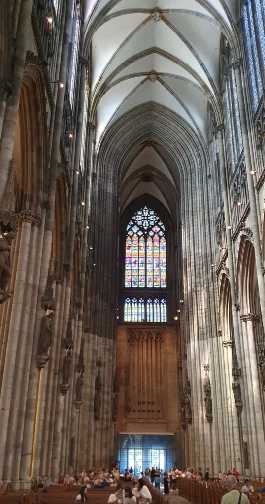Tall compound piers, pointed arcades, a glazed triforium, clerestory windows and rib vaults rise through Cologne Cathedral’s interior.