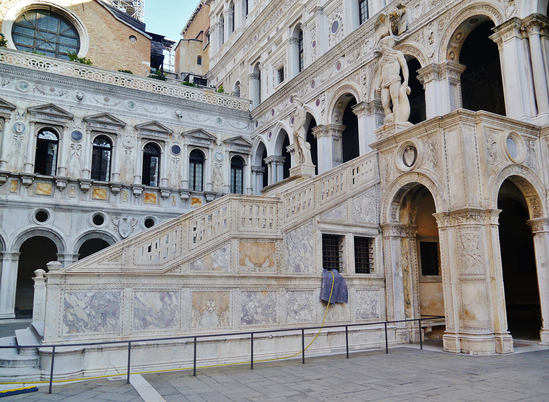 Giants’ Stair and Foscari Arch in the Doge’s Palace courtyard, with the colossal Mars and Neptune above.