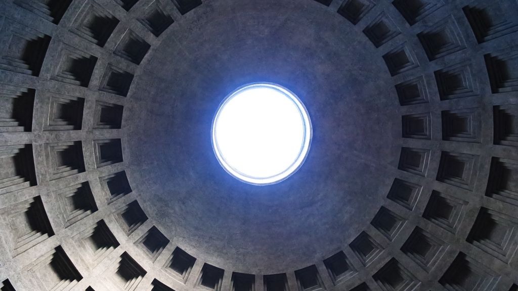 Concentric rings of square coffers curve inward around the brilliant circular oculus at the centre of the Pantheon's concrete dome.