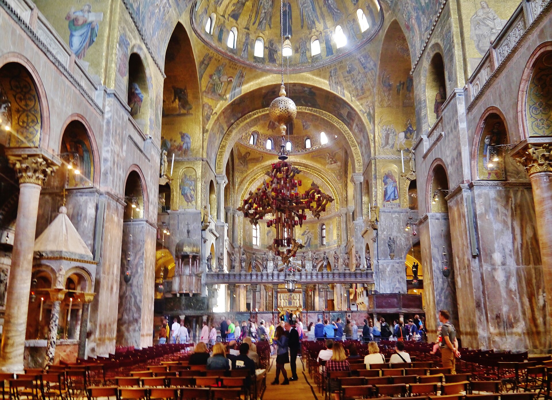 Interior of St Mark’s Basilica looking east through marble-clad piers and mosaic-covered arches towards the sanctuary.