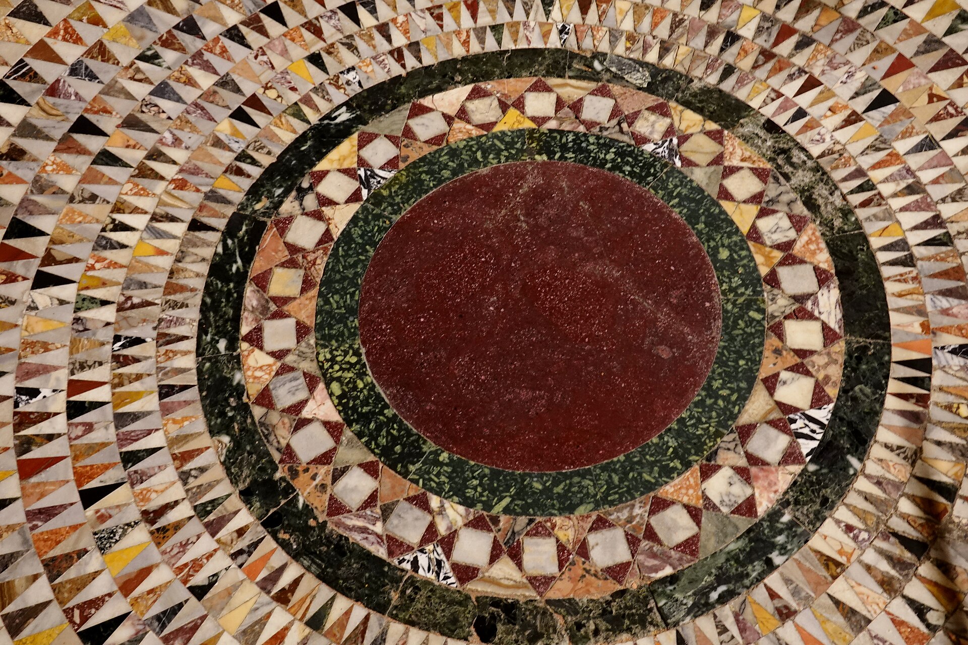 Circular opus sectile pavement field composed of red, green, white and patterned marble at St Mark’s Basilica.