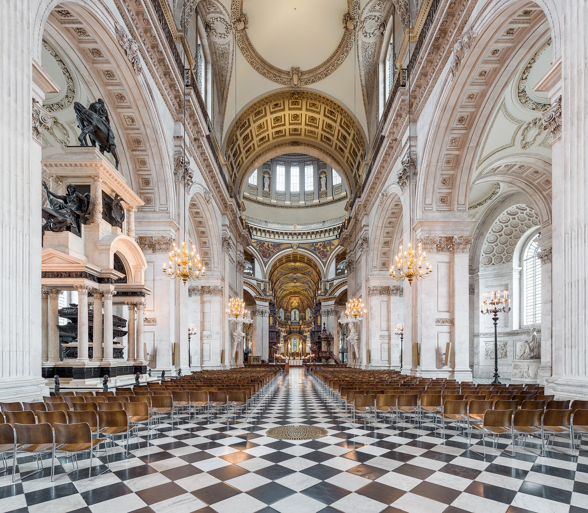 St Paul’s Cathedral nave looking east through repeated arches and colossal pilasters towards the bright crossing and choir.