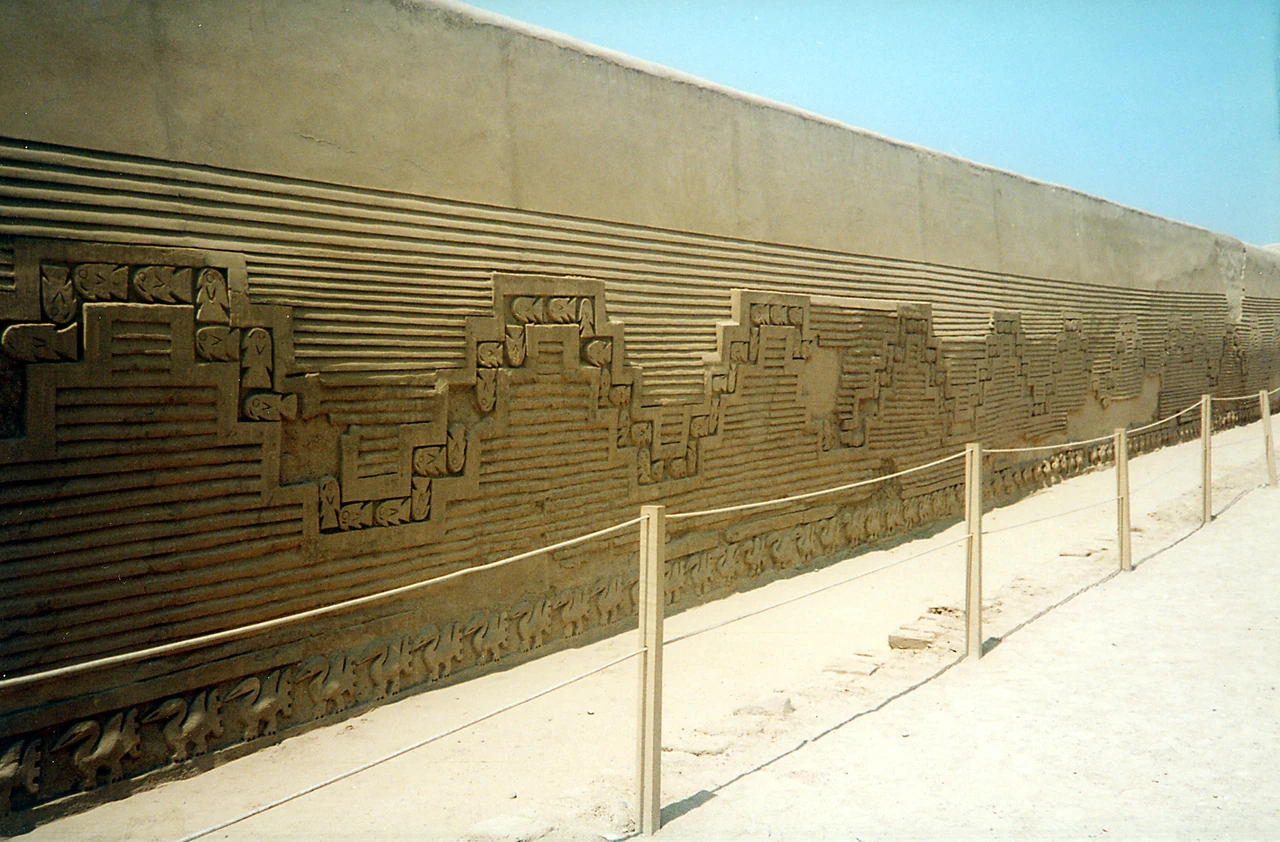 Chan Chan wall relief with repeating stepped forms, horizontal grooves and smaller motifs.