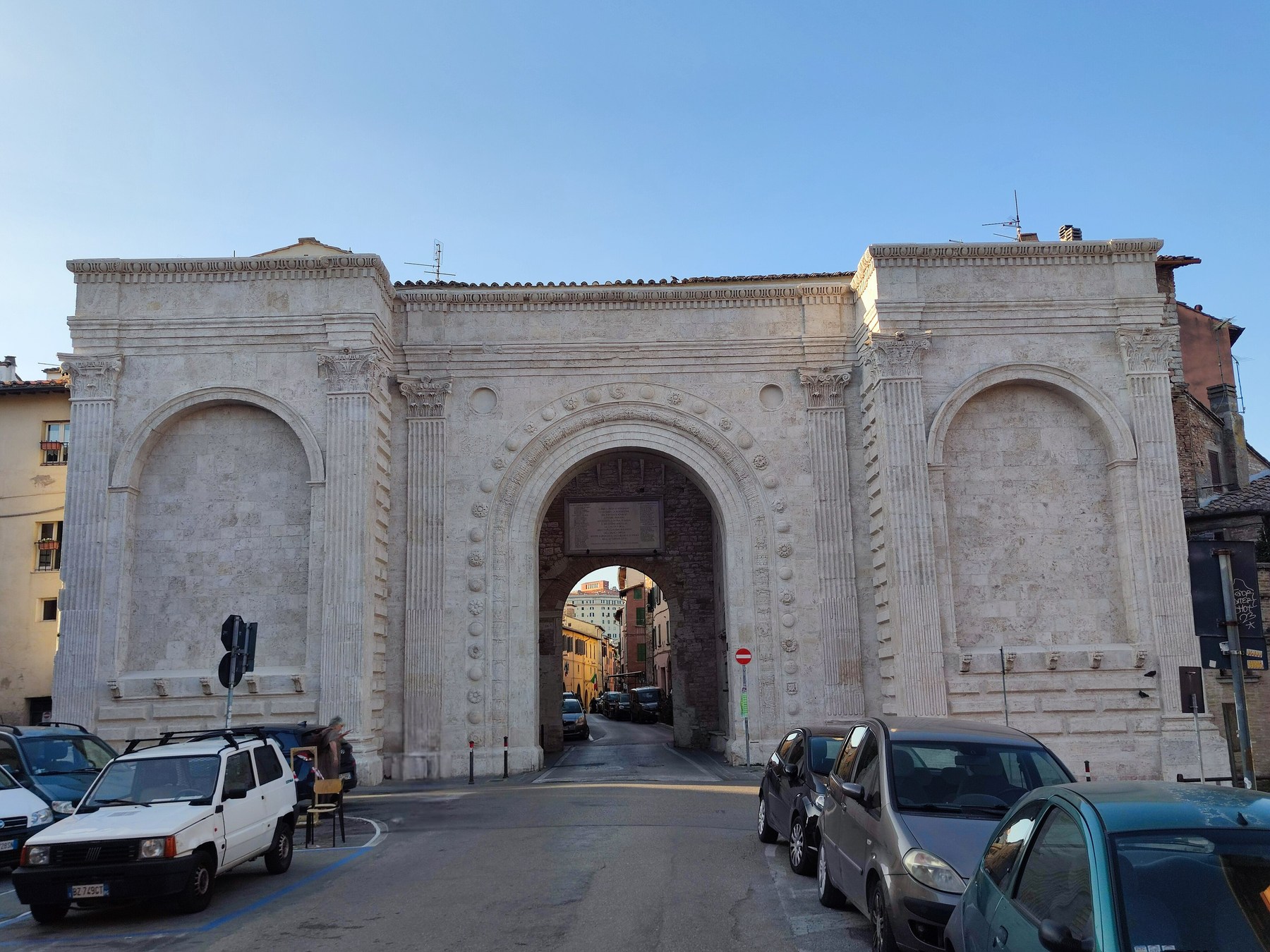 Porta San Pietro in Perugia, with a central arched passage and articulated stone surfaces.