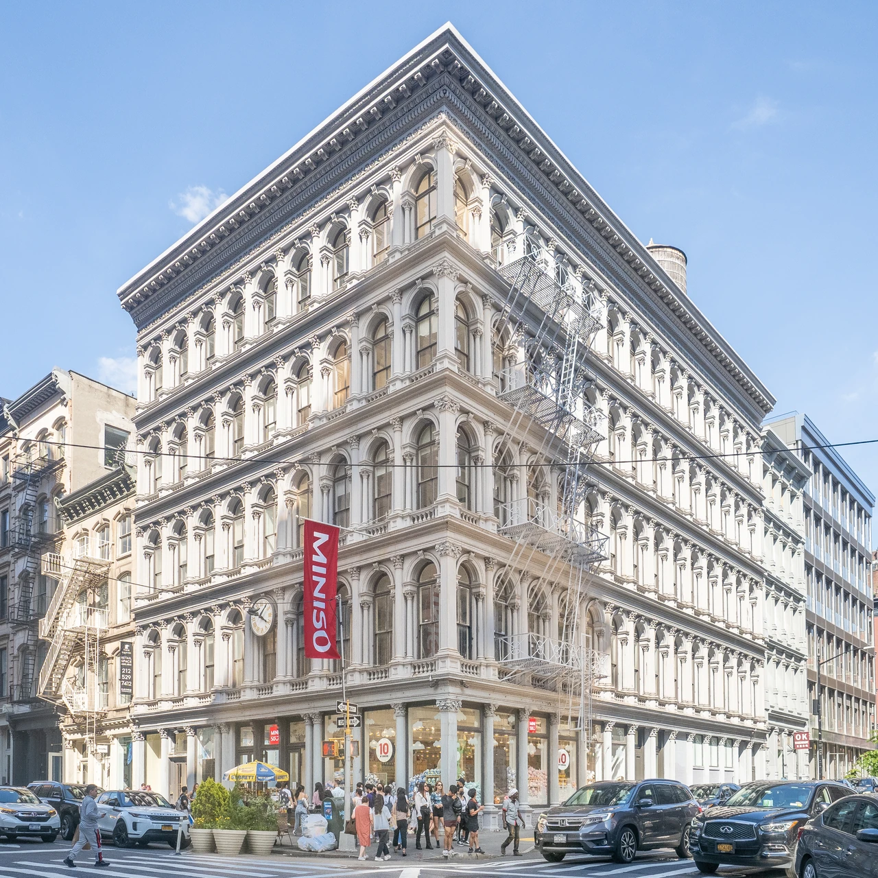 Cream-painted columns, arched window bays and mouldings repeat across the two street faces of the Haughwout Building.