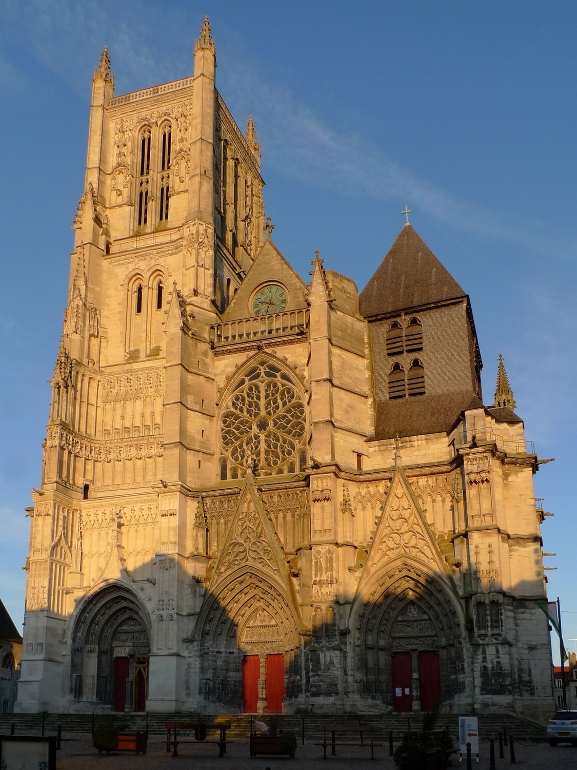 Meaux Cathedral's stone west front, with a smaller shingle-covered tower and steep roof above the right-hand portal.