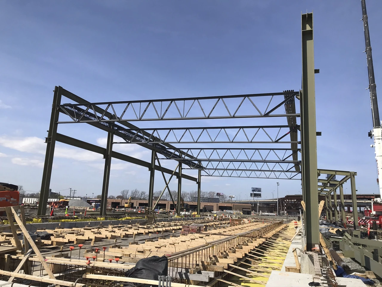 Exposed steel columns and roof trusses at the GLX construction site.
