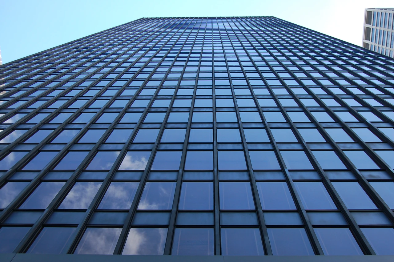 An upward view of Seagram’s upper tower shows repeated vertical raised façade profiles and horizontal divisions across its glazing.
