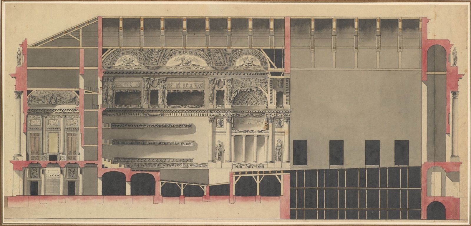 Long theatre section with pink cut walls, stage and auditorium boxes under a timber roof.