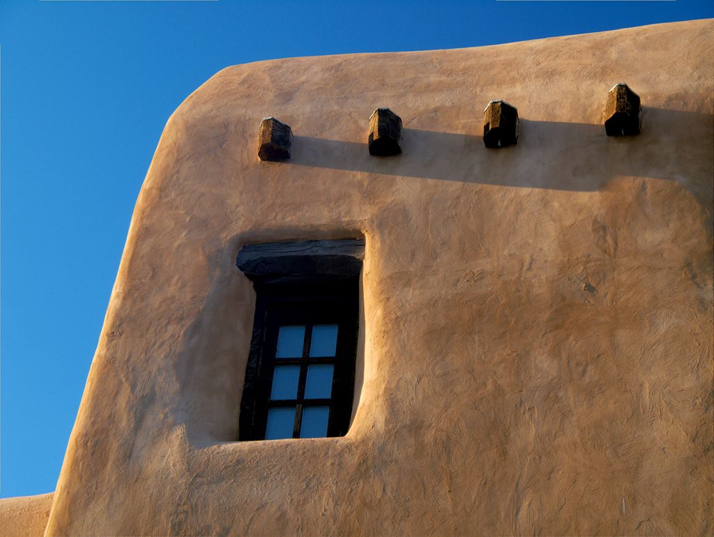 Projecting timber ends above a recessed window at the New Mexico Museum of Art.