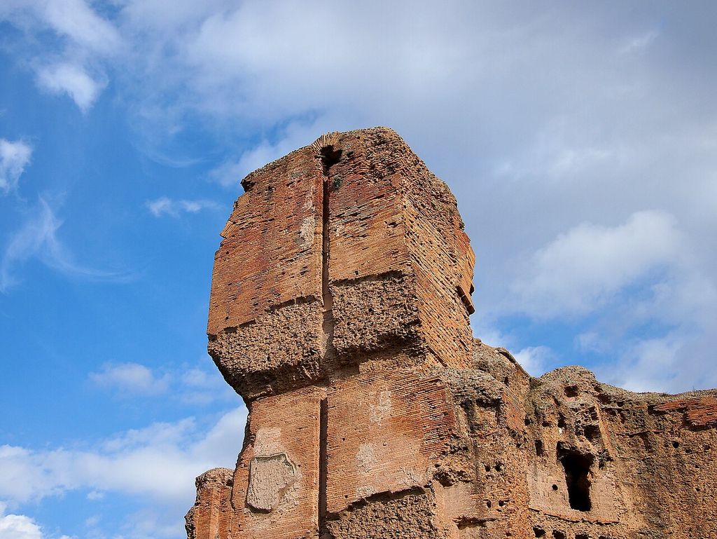 Tall Roman ruin with ceramic facing and exposed rough core material.
