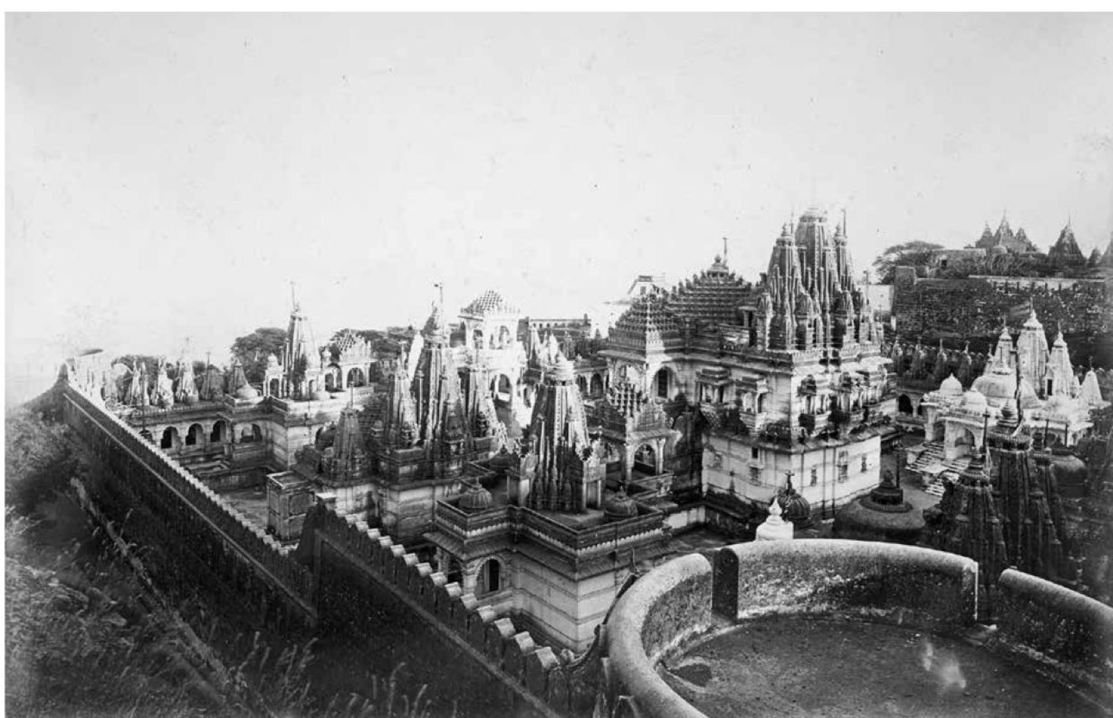 Black-and-white 1869 panorama across the clustered Jain shrines and enclosing walls of Motisah Tuk at Shatrunjaya.