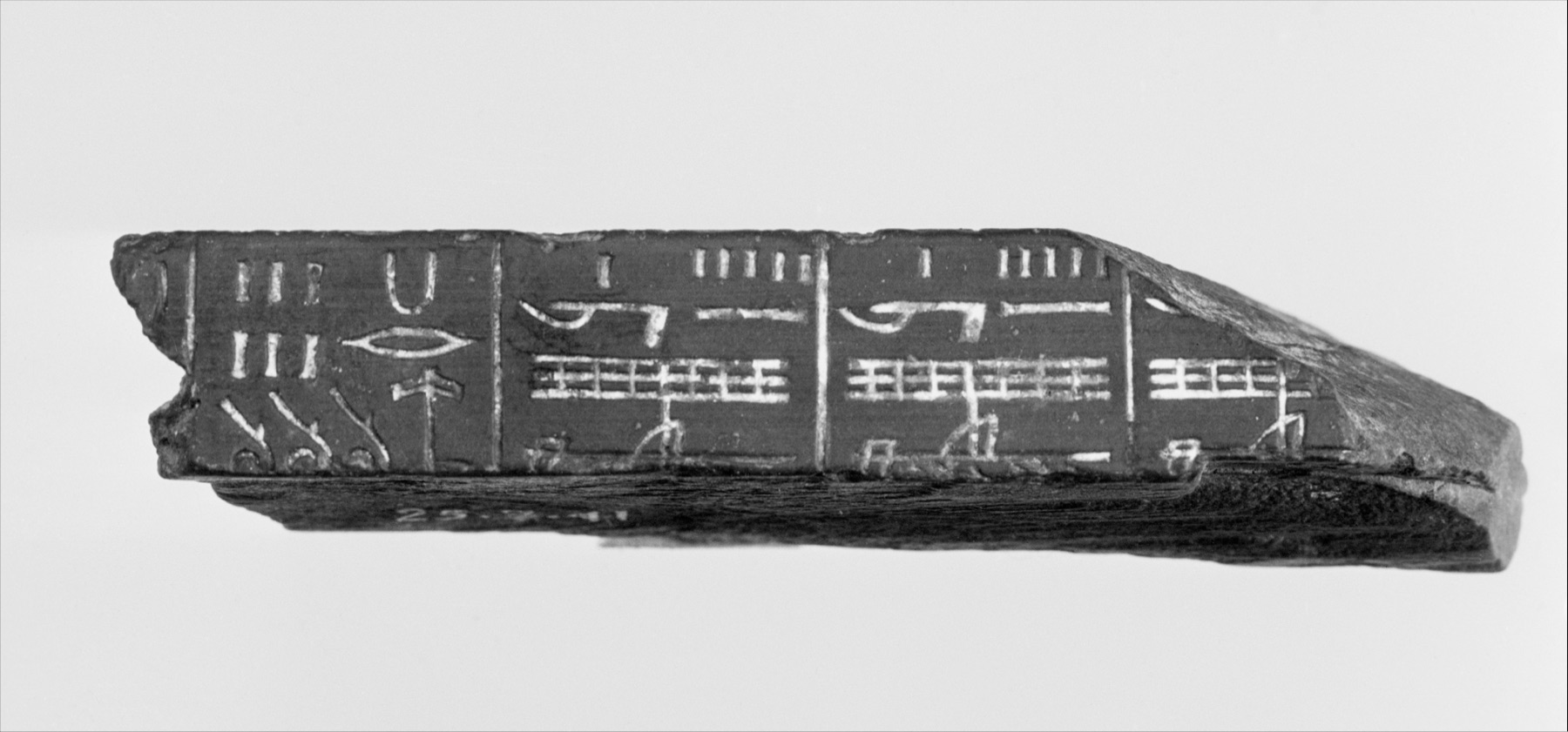 Metropolitan Museum New Kingdom wooden cubit-rod fragment with visible inscribed measurement divisions.