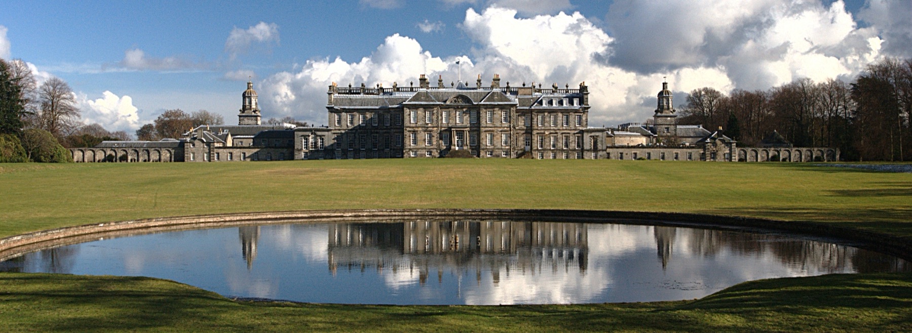 Photograph across ornamental pool to the garden rear facade of Hopetoun House near Edinburgh.