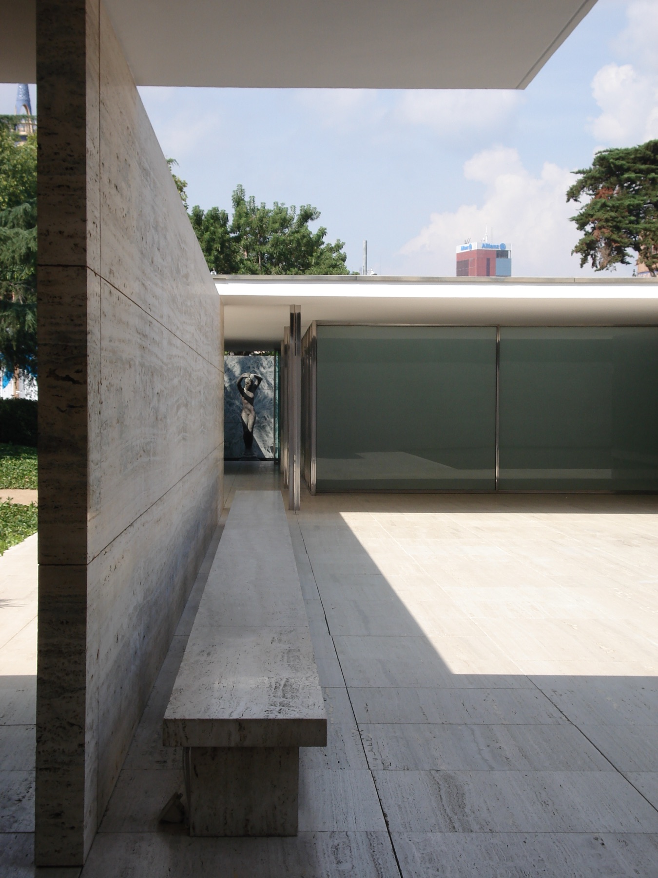 2012 photograph of the reconstructed Barcelona Pavilion with offset travertine wall and glass planes.