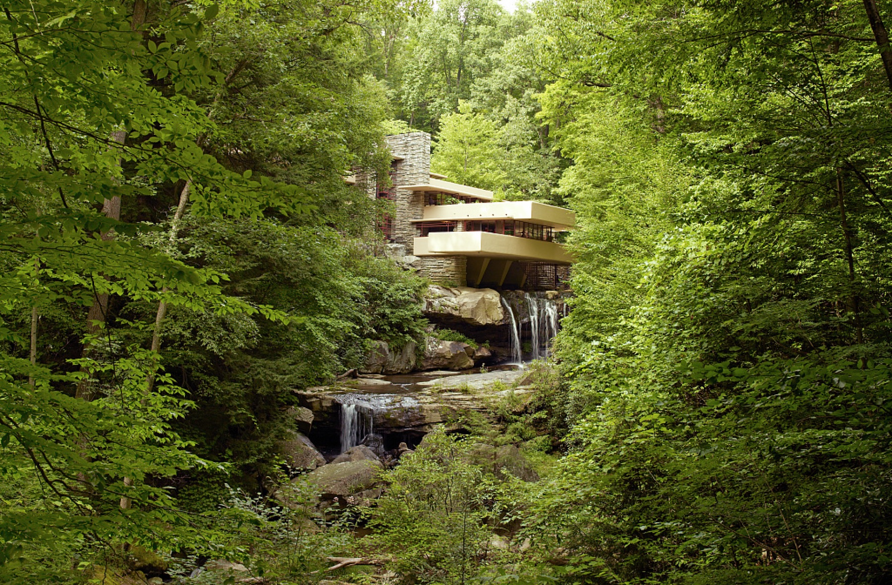 2007 colour photograph of Fallingwater terraces over stream and cascade among trees.