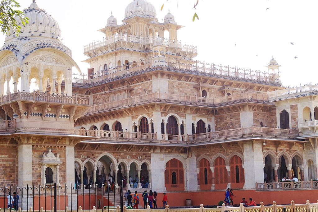 Domed pavilions, bracketed eaves, screens and pointed arcades overlap across an elaborate museum front.