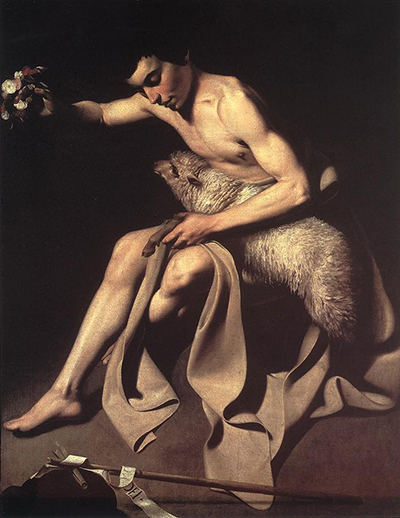 A young John sits in a dark setting and draws a lamb close to his body.