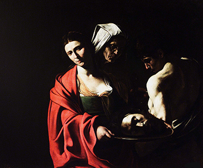 Madrid Salome in a vivid red cloak beside the executioner and the Baptist’s head.