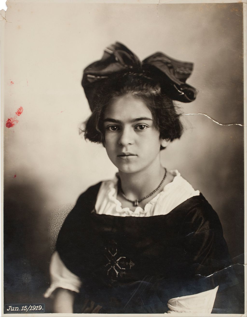 Black-and-white childhood portrait of Frida Kahlo in 1919.
