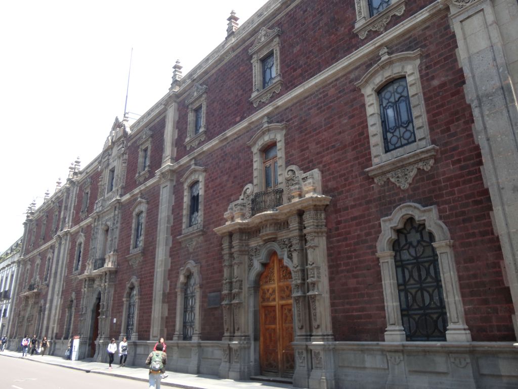 Stone facade and arched entrance of the Antiguo Colegio de San Ildefonso in Mexico City.