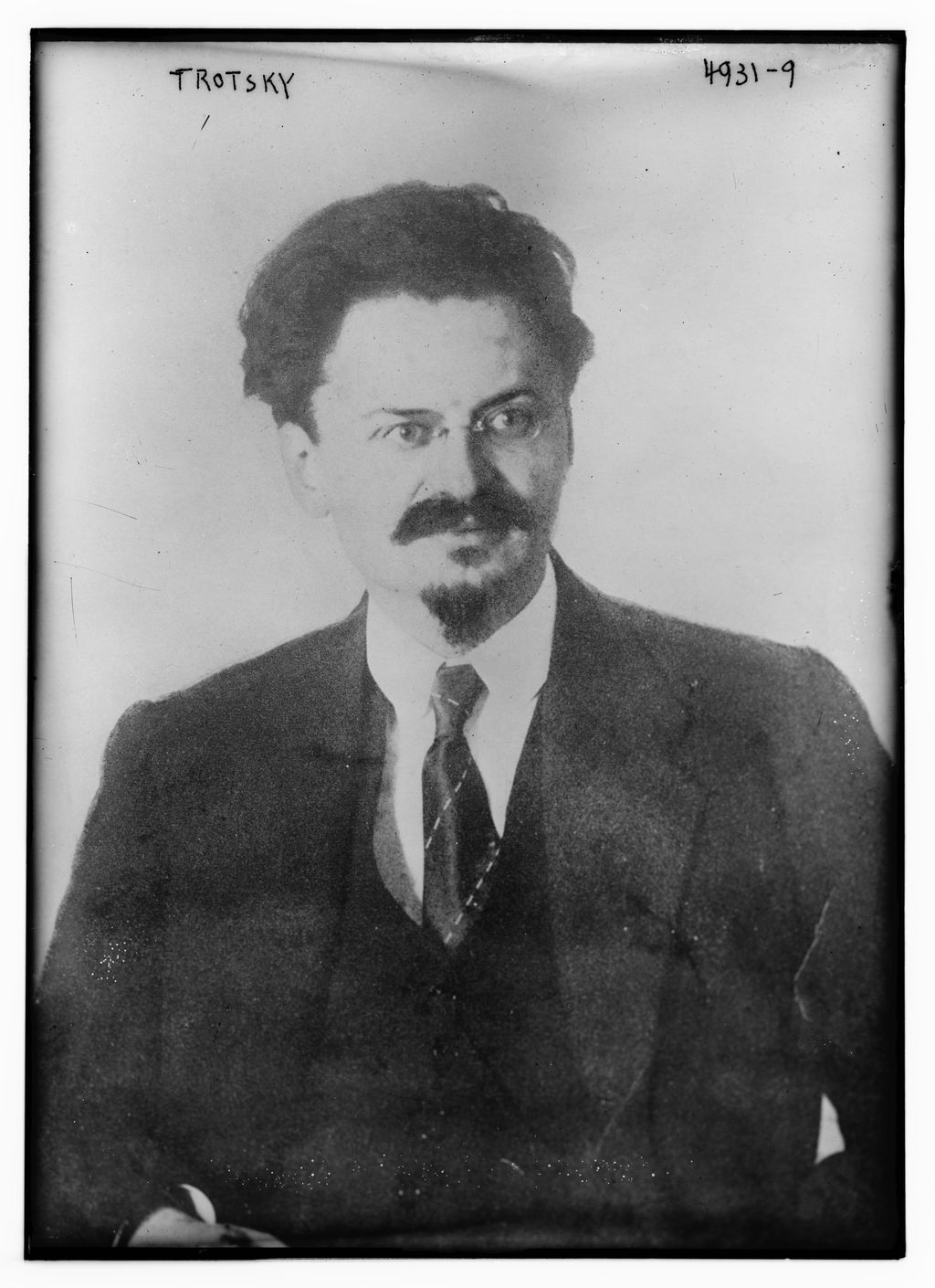 Black-and-white studio portrait of Leon Trotsky looking directly toward the camera.