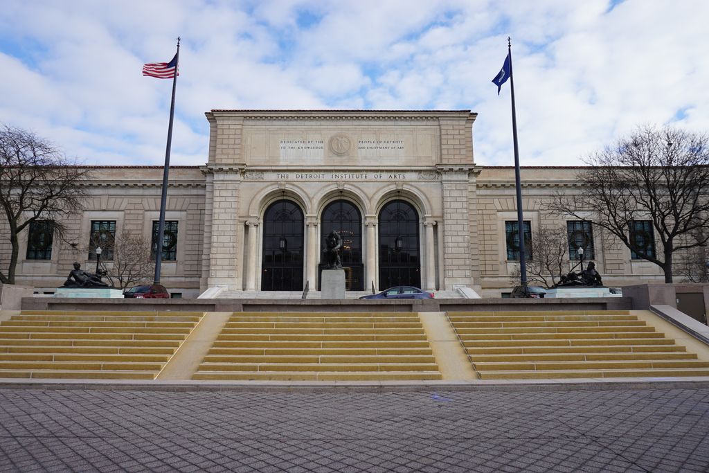 Detroit Institute of Arts entrance with broad steps, columns, flags and winter trees.