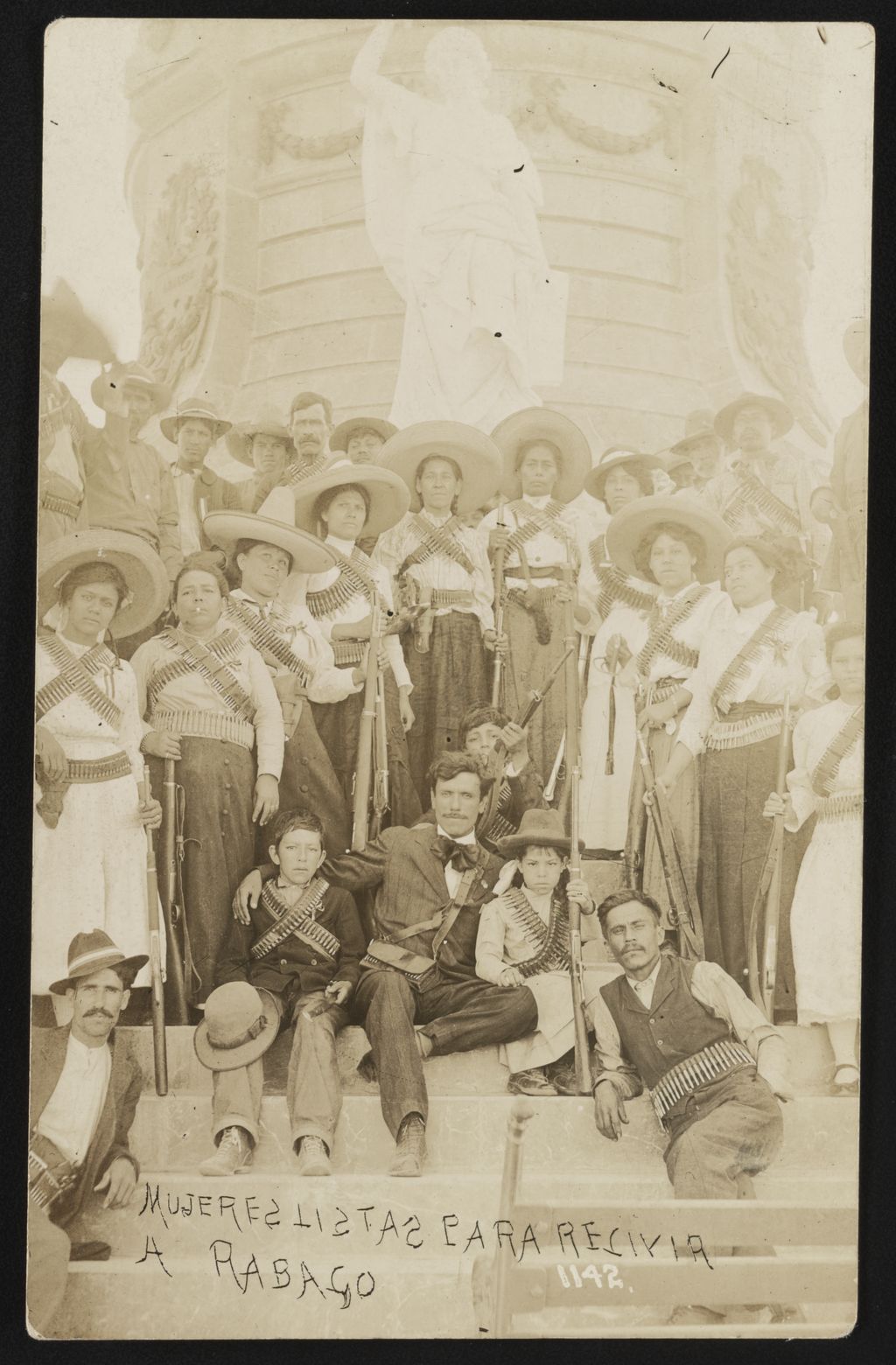 Carte postale historique d’un groupe, principalement de femmes, rassemblé autour d’un monument à Ciudad Juárez.