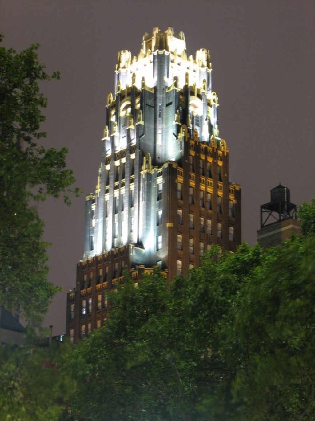 Photograph of American Radiator Building at night.