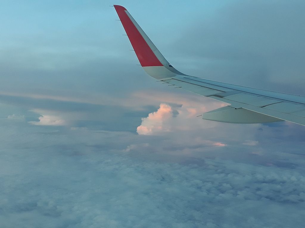 Photograph of Clouds photographed from an aircraft window.