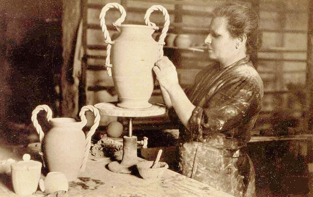 Contextual image of twisted handles being fitted to pottery at vallauris.