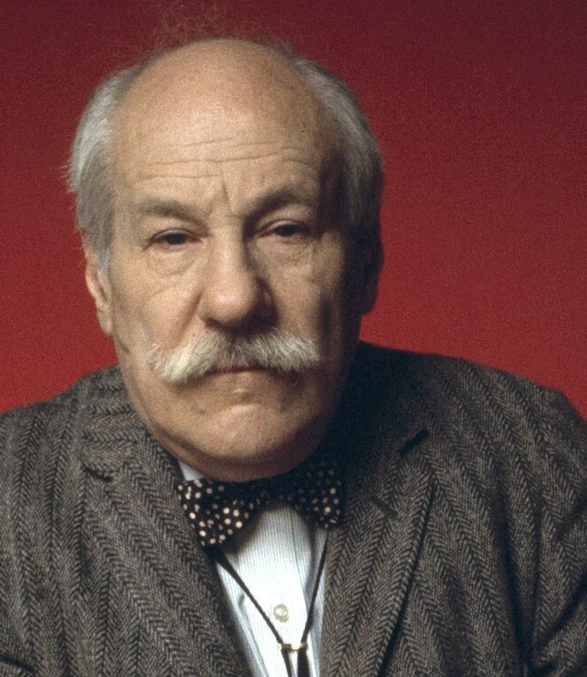 A portrait detail of Barnett Newman, with a moustache and patterned bow tie.