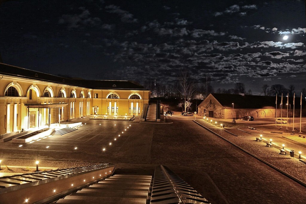 The illuminated former arsenal and courtyard of the Daugavpils Rothko Art Centre at night.