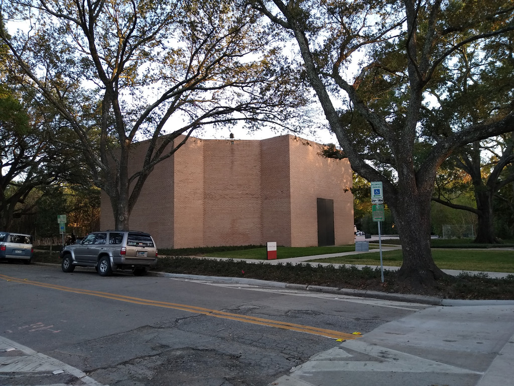 The Rothko Chapel brick exterior seen across a public street beneath trees in 2020.