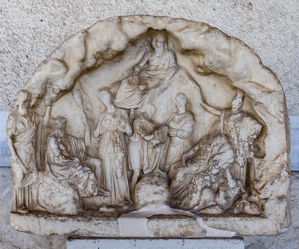 An ancient votive relief of Pan and nymphs, giving visual context to the classical name in The Pipes of Pan.