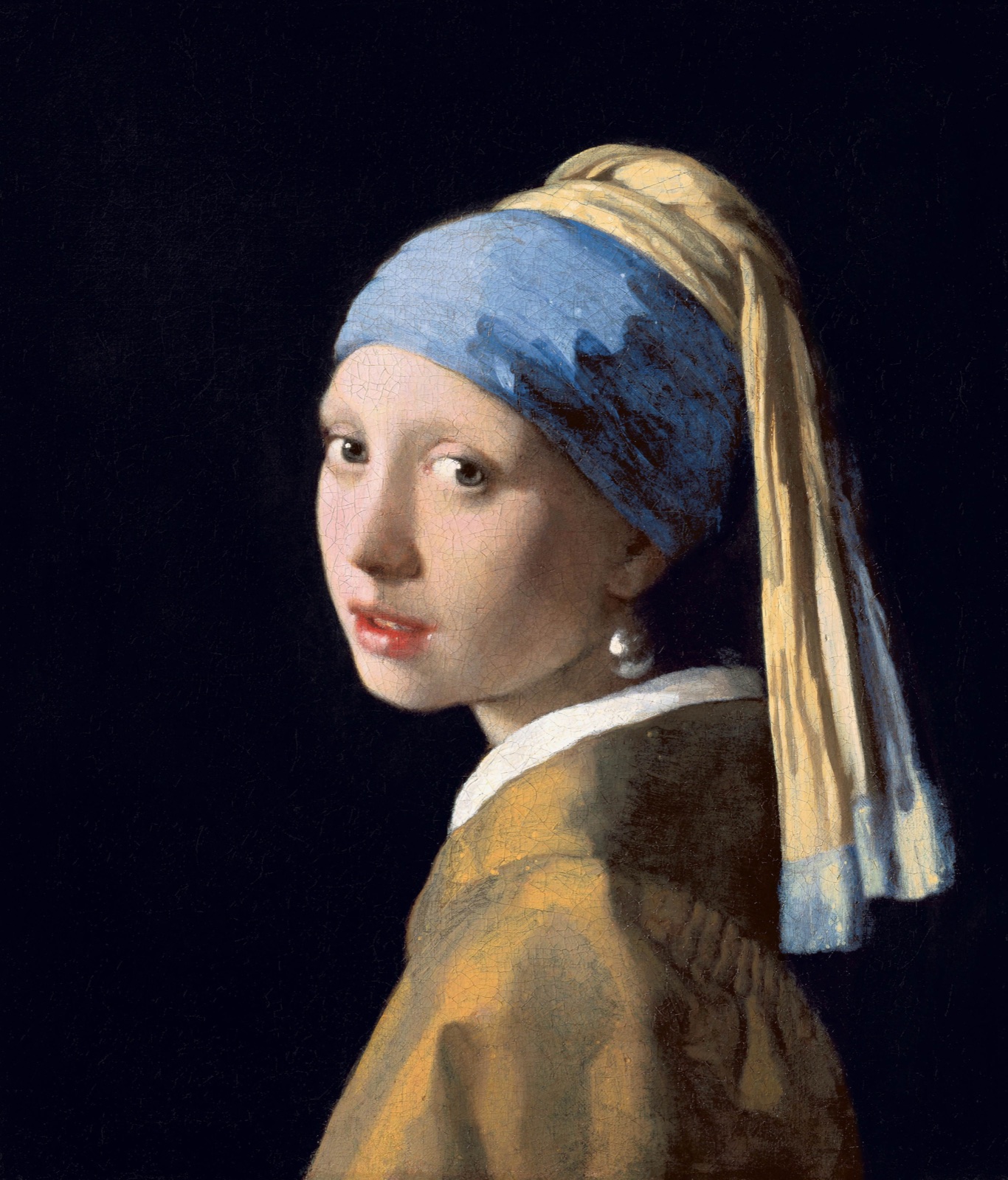 A young woman in a blue and yellow turban turns toward the viewer wearing a pearl earring
