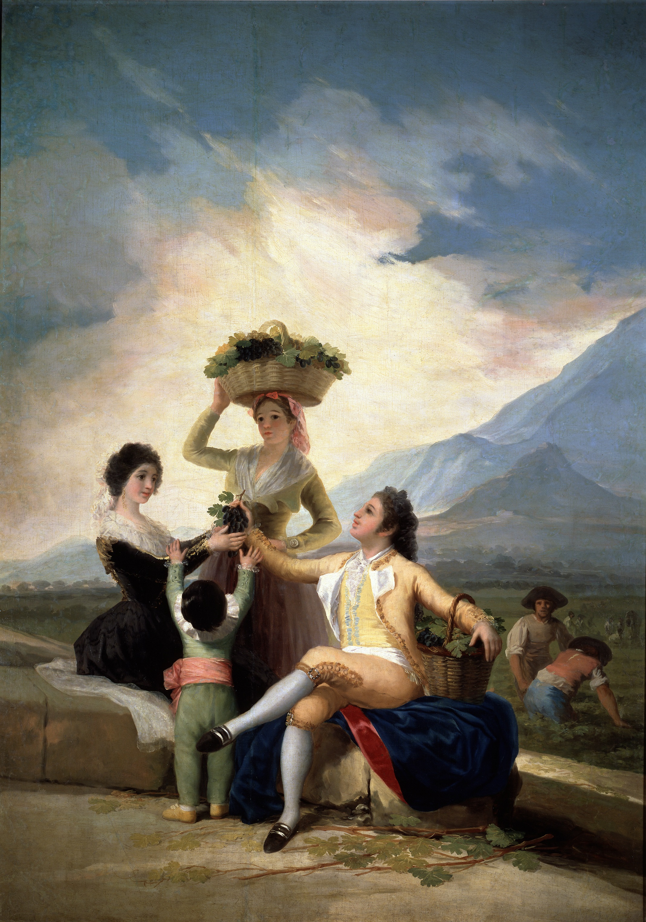 Figures share grapes in the foreground while harvesters work in a vineyard beneath a broad sky in Goya's Autumn.
