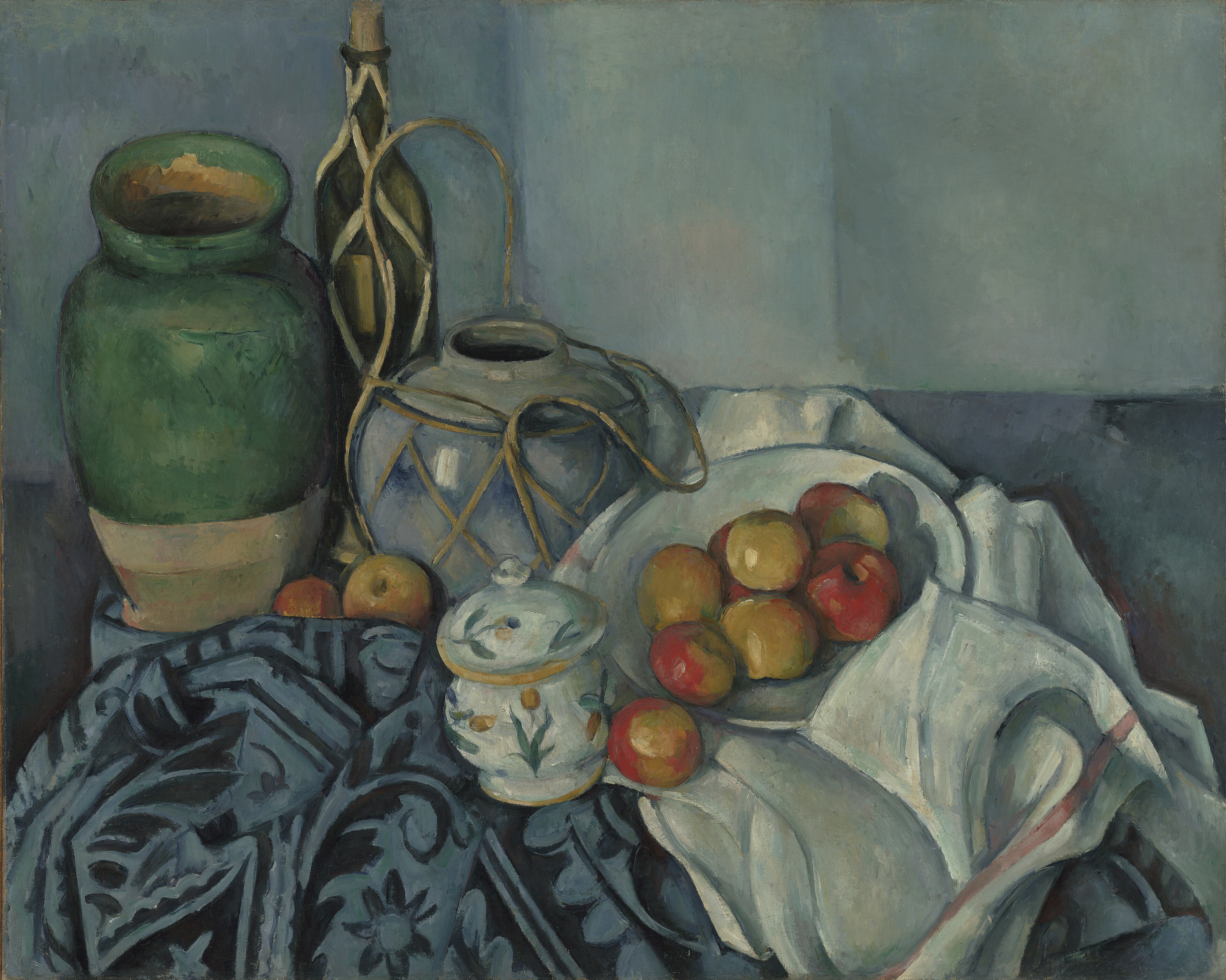 Cézanne's apples, ceramic vessels and rum bottle arranged across patterned cloths in a blue-green interior.