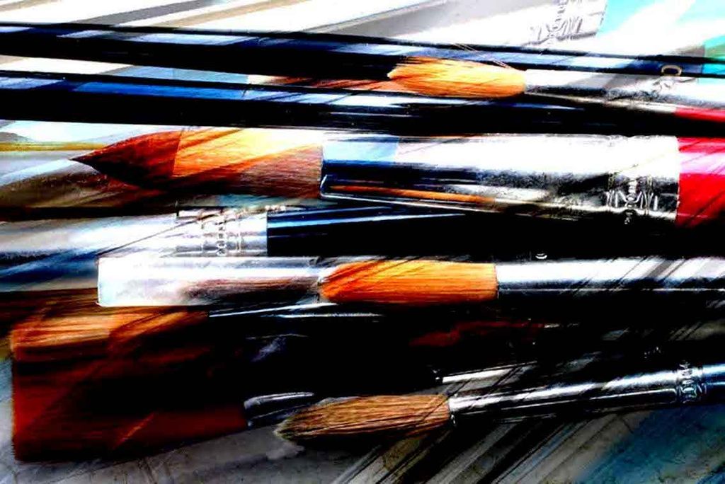 Assorted artist brushes arranged together, with visibly different head sizes and shapes.