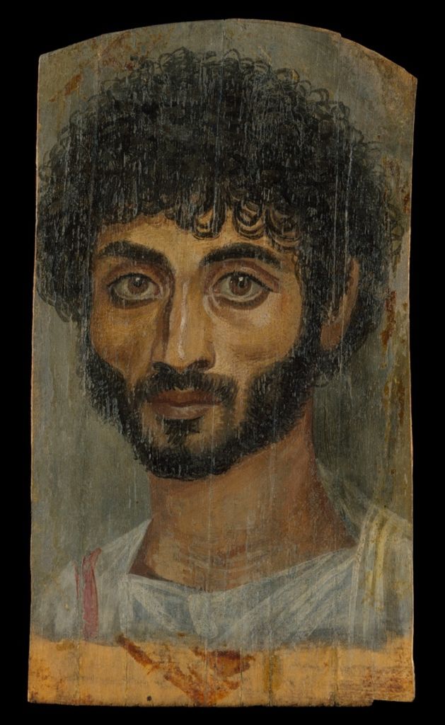 Roman-period portrait in encaustic paint on a narrow limewood panel, joining binder, pigment, preparation and support in one object.