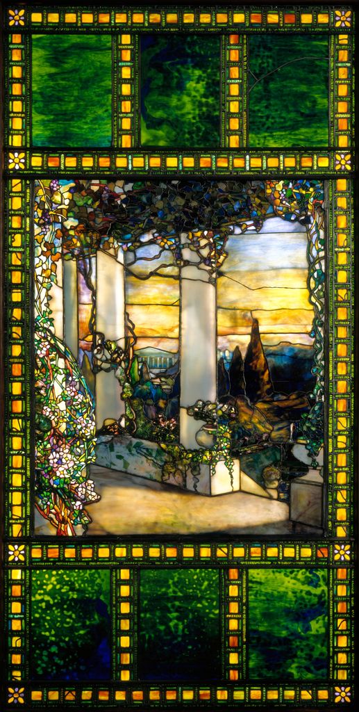 Layered leaded glass forms green framing, amber border modules, white columns, garden plants and a sunset landscape.