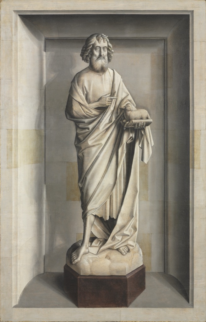 A standing saint and lamb are modeled in gray oil paint to resemble sculpture within a deep architectural niche.